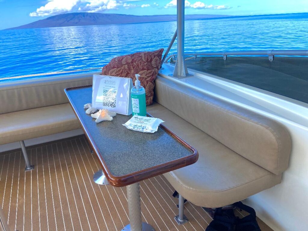 Fly Bridge helm and port table aboard Hula Girl